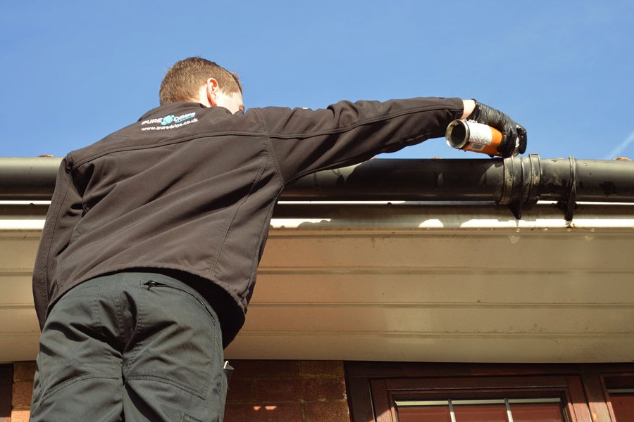 Callum cleaning gutter